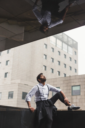 Portrait of a young handsome Indian man posing in an urban contextの写真素材