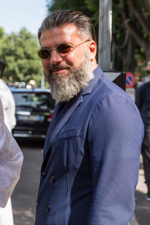MILAN, ITALY - JUNE 21: Fashionable man poses outside Armani fashion show building during Milan Men's Fashion Week on JUNE 21, 2016 in Milan.のeditorial素材