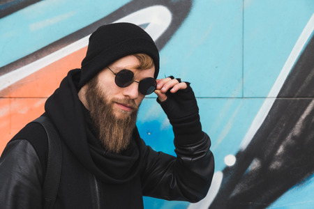 Stylish young bearded man posing in an urban contextの写真素材