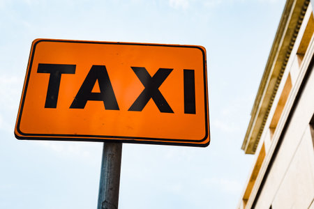 Detail of orange taxi roadsign in a city streetの写真素材