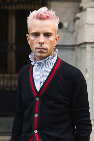 MILAN, ITALY - SEPTEMBER 21, 2016: Fashionable man poses outside Fausto Puglisi fashion show building during Milan Women Fashion Week SS17.のeditorial素材