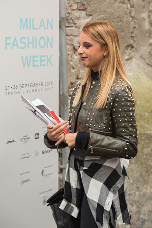 MILAN, ITALY - SEPTEMBER 21, 2016: Fashionable woman poses outside Blugirl fashion show building during Milan Women Fashion Week SS17.のeditorial素材