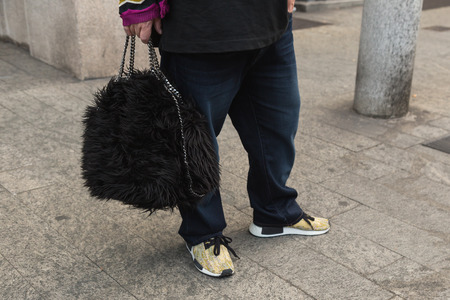 MILAN, ITALY - SEPTEMBER 21, 2016: Detail of bag and shoes outside Fausto Puglisi fashion show building during Milan Women Fashion Week SS17.のeditorial素材