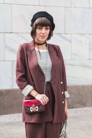 MILAN, ITALY - SEPTEMBER 22, 2016: Fashionable woman poses outside Genny fashion show building during Milan Women Fashion Week SS17.のeditorial素材
