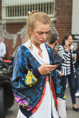 MILAN, ITALY - SEPTEMBER 22, 2016: Fashionable woman poses outside Fendi fashion show building during Milan Women Fashion Week SS17.のeditorial素材