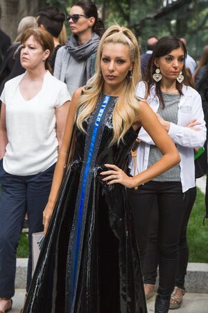 MILAN, ITALY - SEPTEMBER 23, 2016: Fashionable woman poses outside Armani fashion show building during Milan Women Fashion Week SS17.のeditorial素材