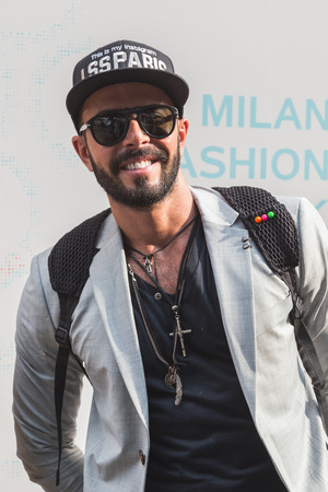 MILAN, ITALY - SEPTEMBER 23, 2016: Fashionable man poses outside Marco De Vincenzo fashion show building during Milan Women Fashion Week SS17.のeditorial素材