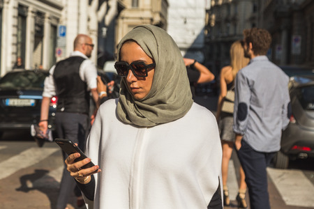 MILAN, ITALY - SEPTEMBER 25, 2016: Fashionable woman poses outside Ferragamo fashion show building during Milan Women Fashion Week SS17.のeditorial素材