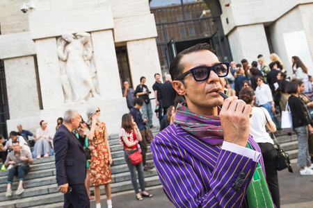 MILAN, ITALY - SEPTEMBER 25, 2016: Fashionable man poses outside Ferragamo fashion show building during Milan Women Fashion Week SS17.のeditorial素材