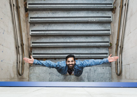 Handsome Indian man posing in an urban context. Street fashion and style.