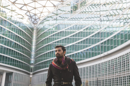 Handsome Indian man posing in an urban context. Street fashion and style.