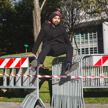 Handsome Indian man posing in an urban context. Street fashion and style.の写真素材
