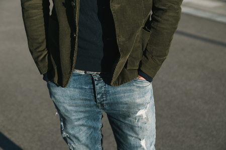 Detail of a young handsome man with short hair posing in an urban contextの写真素材