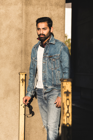 Handsome Indian man posing in an urban context. Street fashion and style.の写真素材