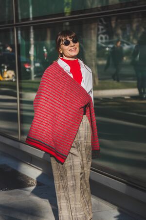 MILAN, ITALY - JANUARY 17: Fashionable woman poses outside Armani fashion show building during Milan Men's Fashion Week on JANUARY 17, 2017 in Milan.のeditorial素材