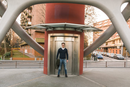 Young handsome man with short hair posing in an urban context