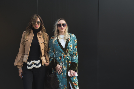 MILAN, ITALY - FEBRUARY 22: Fashionable women pose outside Gucci fashion show building during Milan Women's Fashion Week on FEBRUARY 22, 2017 in Milan.のeditorial素材