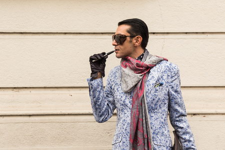 MILAN, ITALY - FEBRUARY 24: Fashionable man poses outside Etro fashion show during Milan Women's Fashion Week on FEBRUARY 24, 2017 in Milan.のeditorial素材