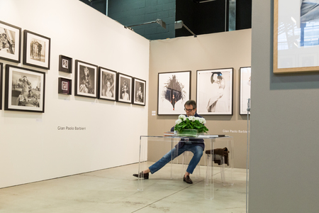 MILAN, ITALY - MARCH 10: Exhibitor in his stand at MIA, international photography and moving image art fair on MARCH 10, 2017 in Milan.のeditorial素材