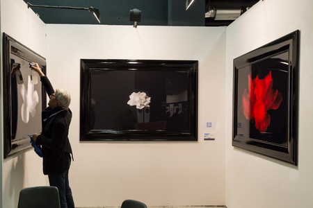 MILAN, ITALY - MARCH 10: Exhibitor in his stand at MIA, international photography and moving image art fair on MARCH 10, 2017 in Milan.のeditorial素材
