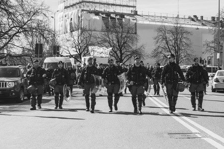 MILAN, ITALY - MARCH 8: Policemen follow the secondary school students while taking part in a march to celebrate the International Wome's Day on MARCH 8, 2017 in Milan.のeditorial素材