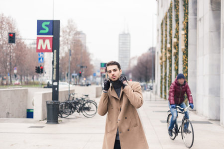 Beautiful young man with short hair posing in an urban context