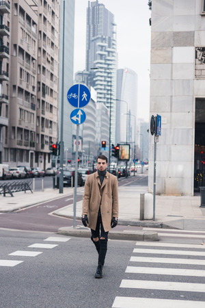 Beautiful young man with short hair posing in an urban contextの写真素材