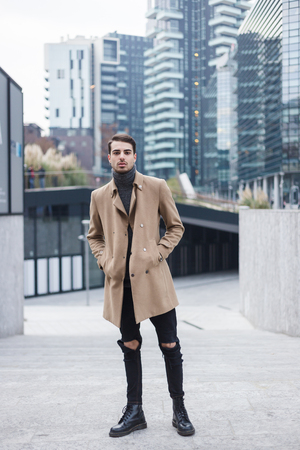 Beautiful young man with short hair posing in an urban contextの写真素材