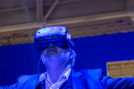 MILAN, ITALY - APRIL 7: Man tries virtual reality headset at Fuorisalone, set of events distributed in different areas of the town during Milan Design Week on APRIL 7, 2017 in Milan.のeditorial素材