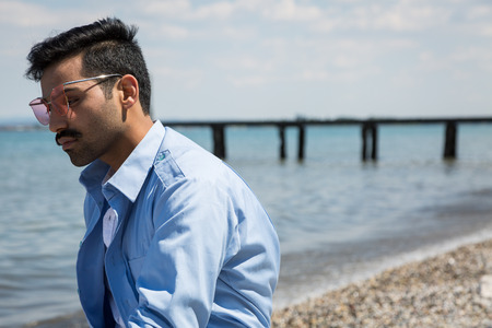 Handsome Indian man posing in a vacation context. Street fashion and style.の写真素材