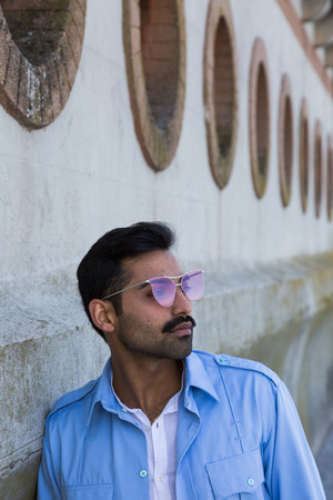 Handsome Indian man posing in an urban context. Street fashion and style.の写真素材