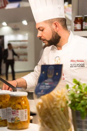 MILAN, ITALY - MAY 9: Cook works at Tuttofood, world food exhibition on MAY 9, 2017 in Milan.のeditorial素材