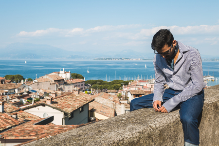Handsome Indian man posing in a vacation context. Street fashion and style.の写真素材