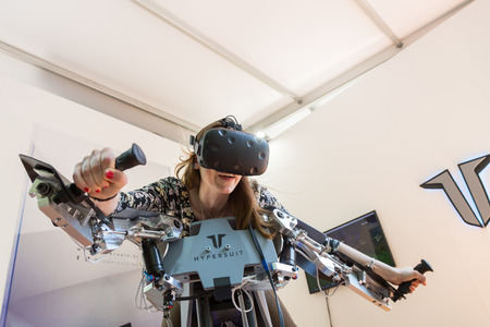 MILAN, ITALY - MAY 26: Girl tries virtual reality headset and flight simulator at Wired Next Fest, event dedicated to future, innovation and creativity on MAY 26, 2017 in Milan.のeditorial素材