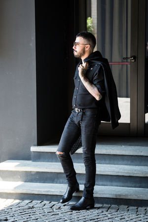 MILAN, ITALY - JUNE 17: Fashionable man poses outside Neil Barrett fashion show during Milan Men's Fashion Week on JUNE 17, 2017 in Milan.のeditorial素材