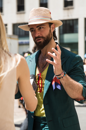 MILAN, ITALY - JUNE 18: Fashionable man poses outside Ferragamo fashion show during Milan Men's Fashion Week on JUNE 18, 2017 in Milan.のeditorial素材