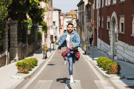 Handsome Indian man posing in an urban context. Street fashion and style.の写真素材