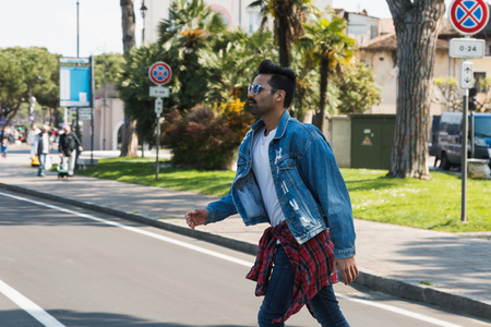 Handsome Indian man posing in an urban context. Street fashion and style.の写真素材