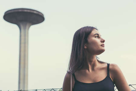 Young beautiful woman with long hair posing in an urban contextの写真素材