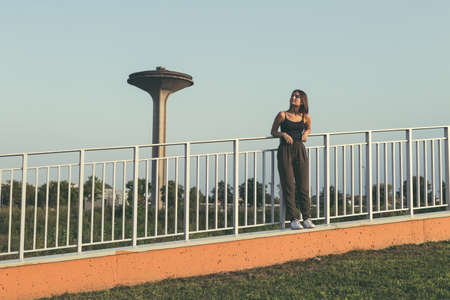 Young beautiful woman with long hair posing in an urban contextの写真素材