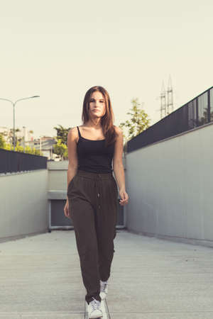 Young beautiful woman with long hair posing in an urban contextの写真素材