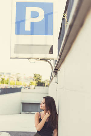 Young beautiful woman with long hair posing in an urban contextの写真素材