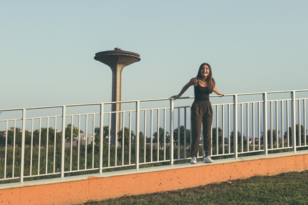 Young beautiful woman with long hair posing in an urban contextの写真素材