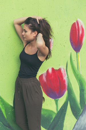 Young beautiful woman with long hair posing in an urban contextの写真素材