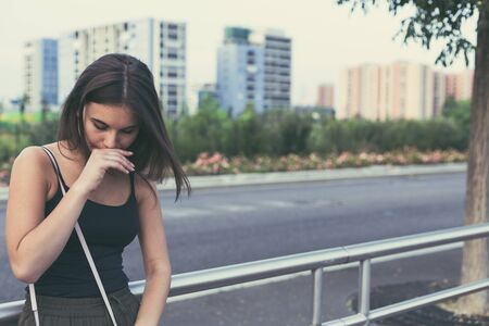 Young beautiful woman with long hair posing in an urban contextの写真素材