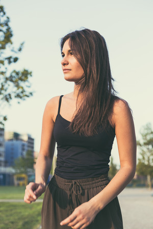 Young beautiful woman with long hair posing in an urban contextの写真素材