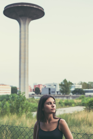Young beautiful woman with long hair posing in an urban contextの写真素材