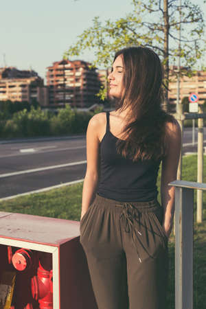 Young beautiful woman with long hair posing in an urban contextの写真素材