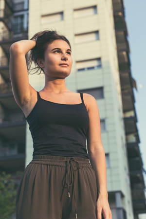 Young beautiful woman with long hair posing in an urban contextの写真素材