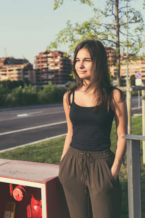 Young beautiful woman with long hair posing in an urban contextの写真素材